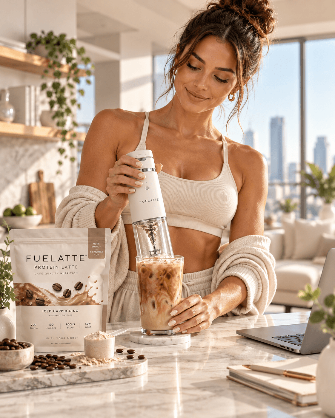 Woman at a sunny kitchen counter mixing an iced FUELATTE protein latte with the electric mixer